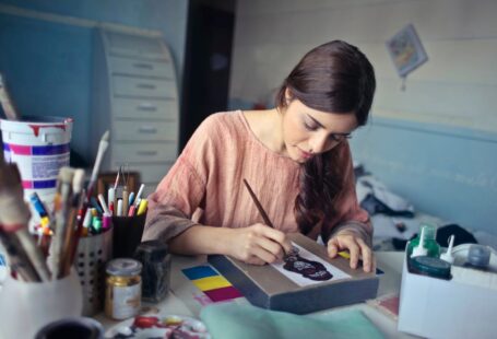 woman-in-brown-scoop-neck-long-sleeved-blouse-painting